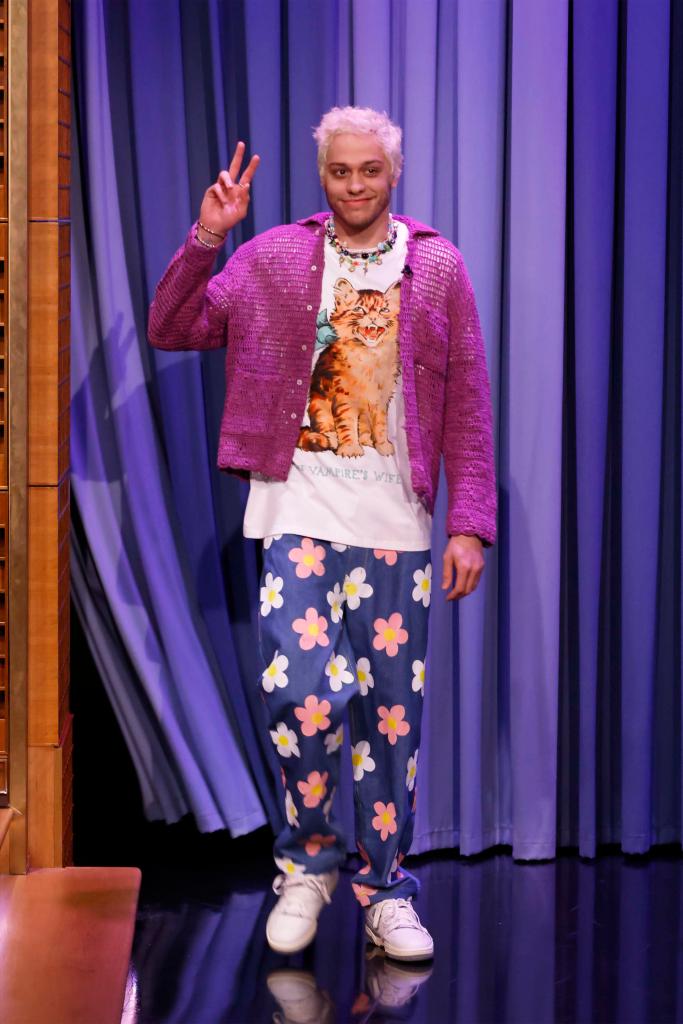 Pete Davidson wears a pink cardigan and floral pants on the Tonight Show with Jimmy Fallon.