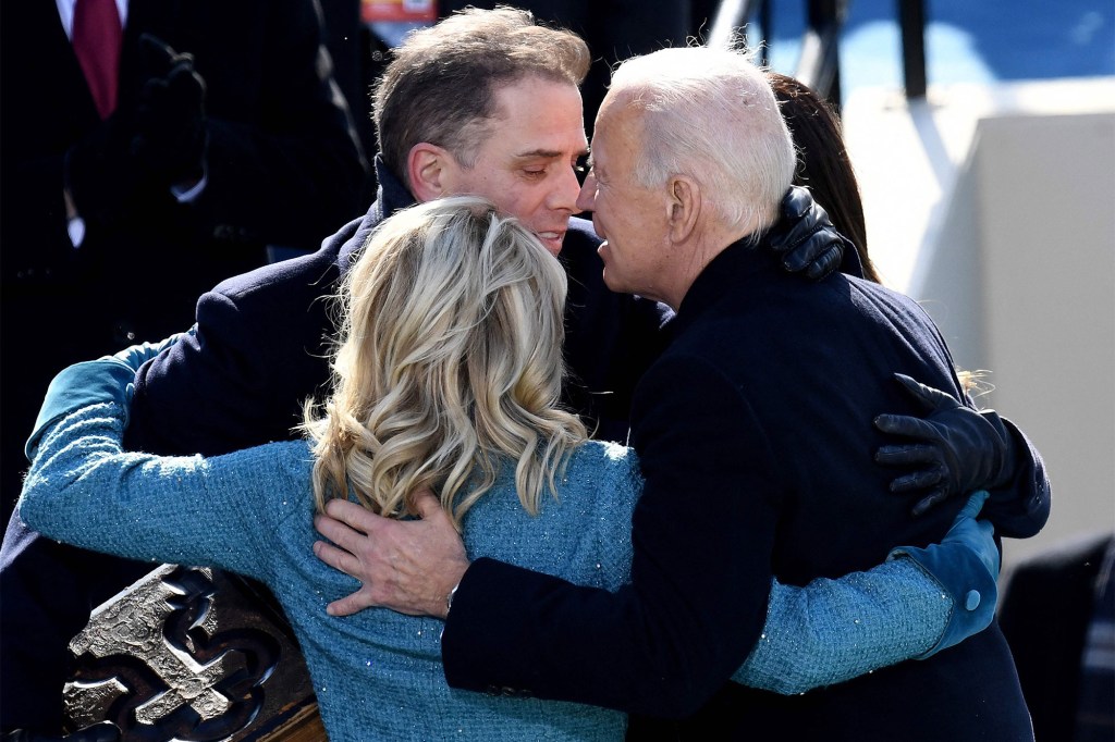 In this file photo US President Joe Biden (R) hugs his son Hunter Biden (C) and US First Lady Jill Biden after being sworn in as the 46th US President, on January 20, 2021.