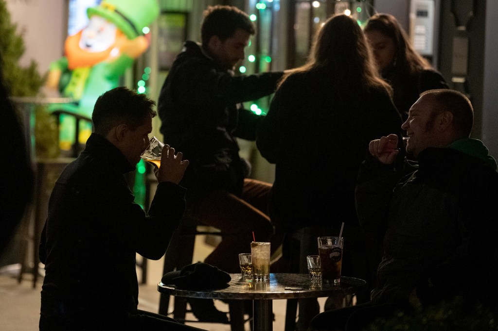 A customer takes a sip of beer at an Irish pub in Chelsea on St. Patrick's Day on March 17, 2021 in New York City