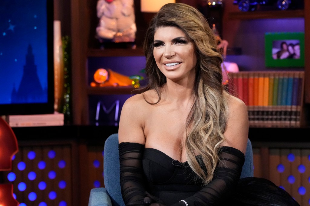 Teresa Giudice wears a shoulder baring black dress. 