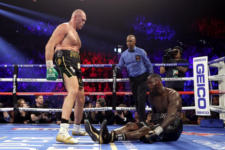 yson Fury knocks down Deontay Wilder in the fifth round during their Heavyweight bout for Wilder's WBC and Fury's lineal heavyweight title on February 22, 2020.
