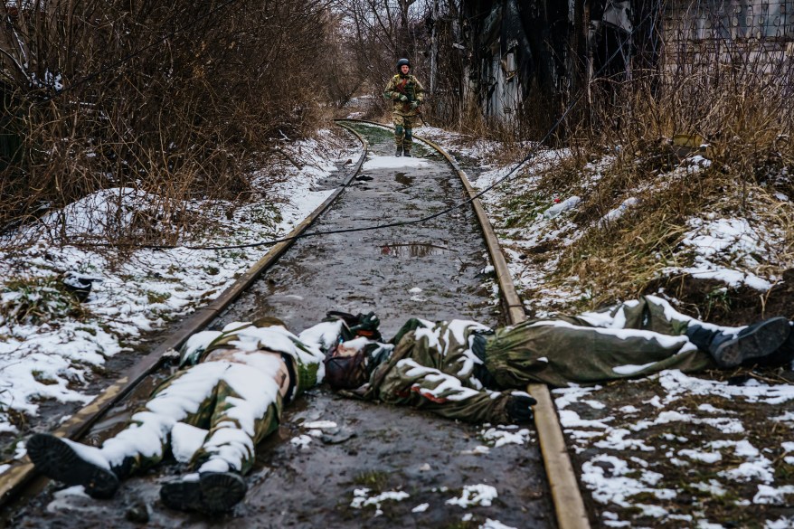 A Ukrainian soldier returns from wandering down the railway, past the bodies of dead Russian soldiers on the outskirts of Irpin, March 1.