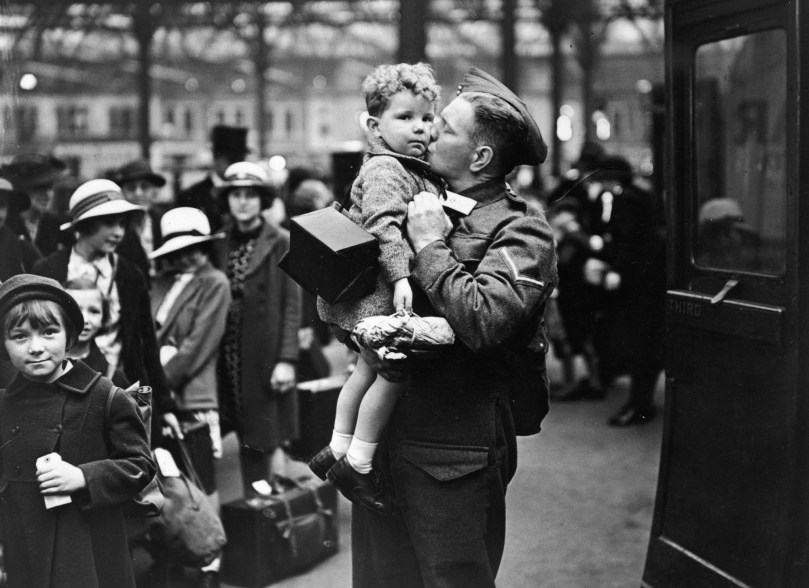 A soldier home on leave from the British Expeditionary Force, says goodbye to his baby son at the evacuation point, June 1940.