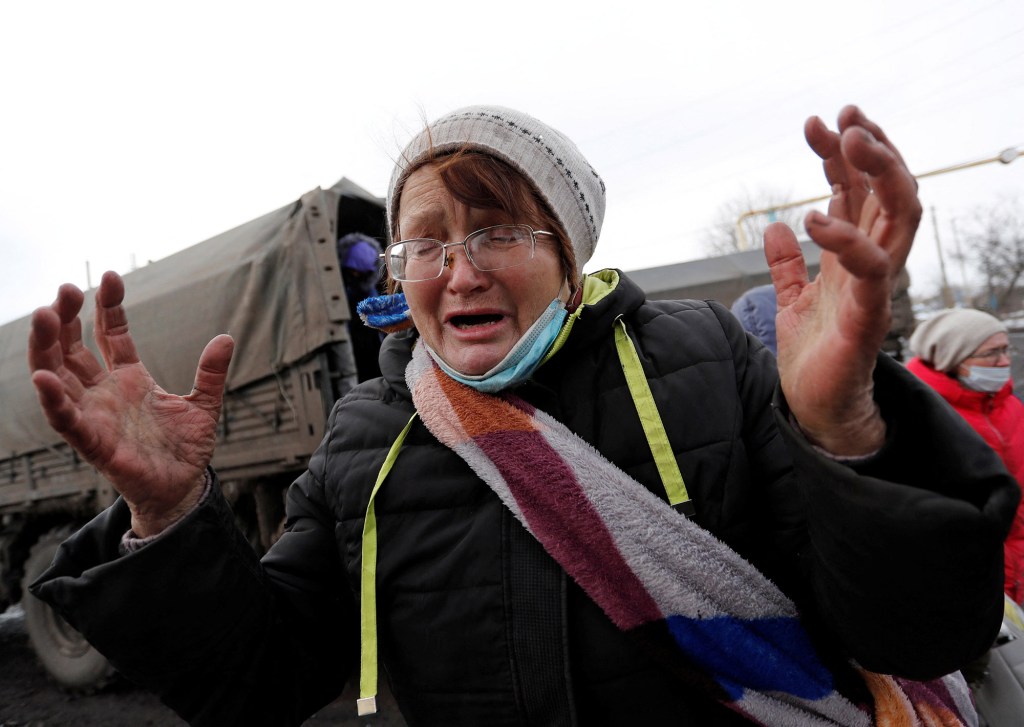 A woman evacuated from Volnovakha reacts upon arrival in the separatist-controlled village of Bugas.