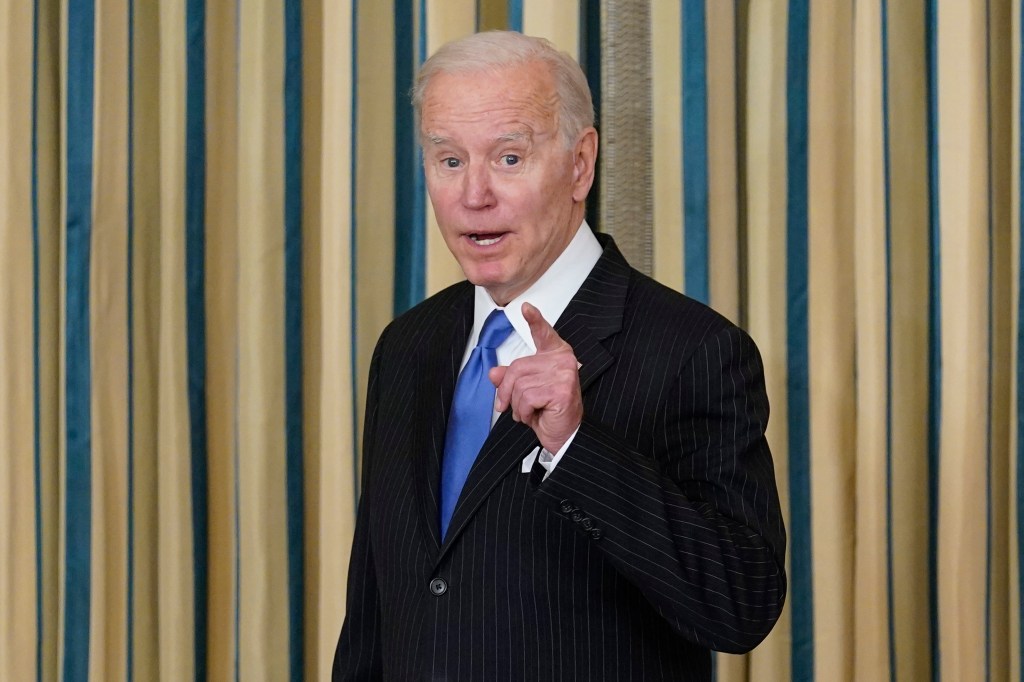 President Joe Biden talks as he leaves after signing the Postal Service Reform Act of 2022 in the State Dining Room at the White House.