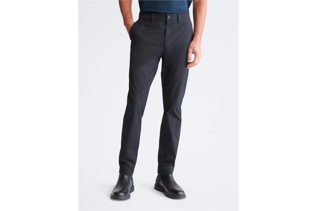 Man in slim fit navy blue dress pants.