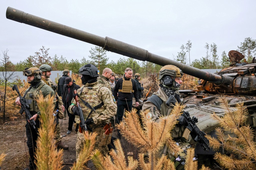 Polish President Andrzej Duda examining destroyed military equipment in a village near Kyiv.