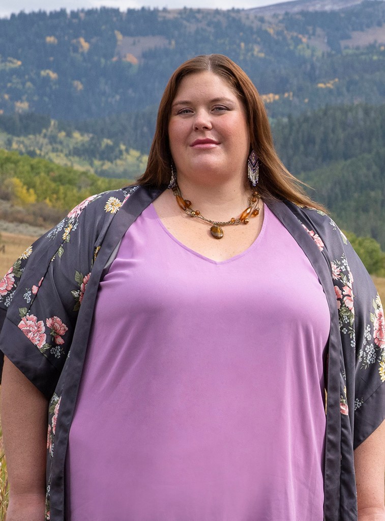 Ella from 90 Day Fiancé: Before the 90 Days poses in a purple shirt. 