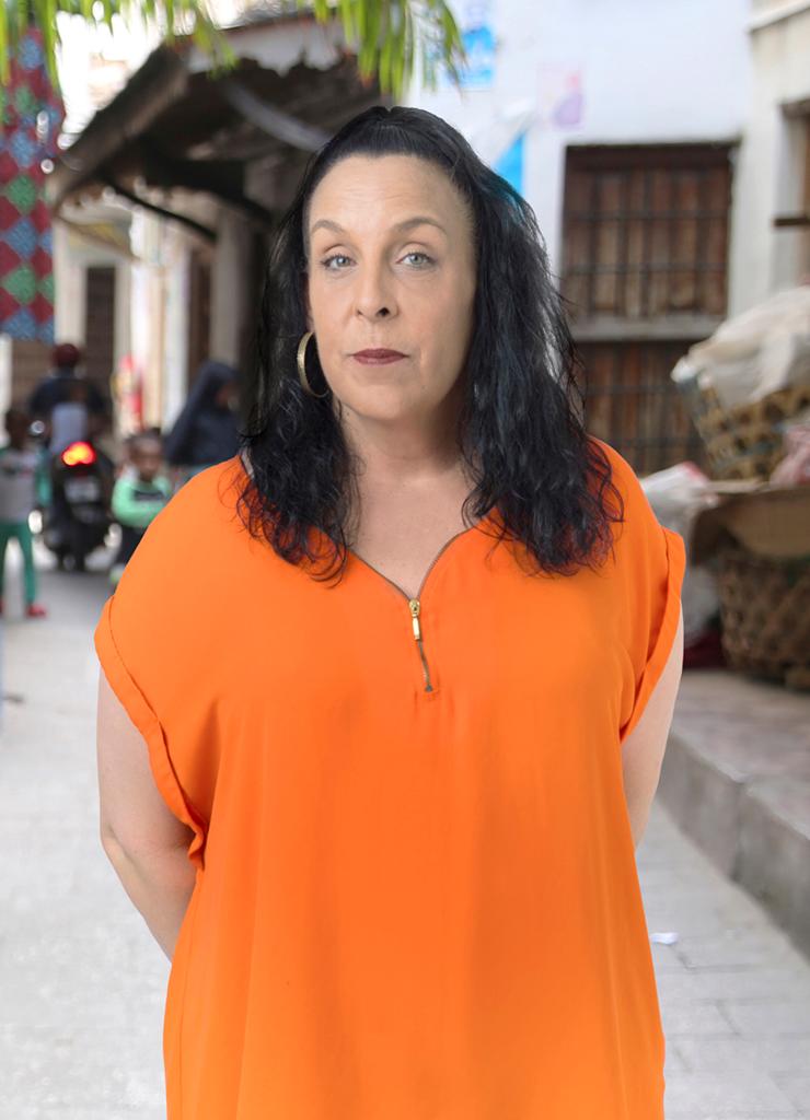 Kim from 90 Day Fiancé: Before the 90 Days poses in an orange shirt.