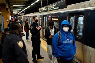 New York City Police Department officers patrol platforms at the 36th Street subway station, April 13, 2022.