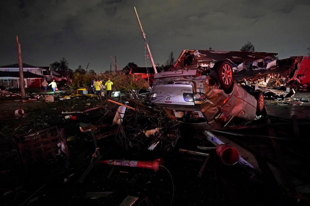 A car is flipped over after a tornado tore through the area in Arabi, La., Tuesday, March 22, 2022. A tornado tore through parts of New Orleans and its suburbs Tuesday night, ripping down power lines and scattering debris in a part of the city that had been heavily damaged by Hurricane Katrina 17 years ago.