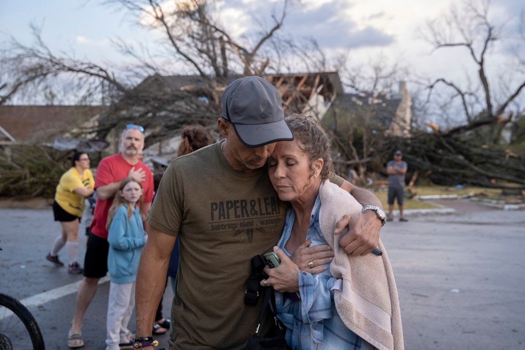 Michael Talamantez comforts his girlfriend Derry Schroer after Talamantez' house on Stratford Drive in Round Rock, Texas was destroyed by a severe storm, reported as a tornado, while they were inside on Monday March 21, 2022. "I thought I was going to die," he said. 