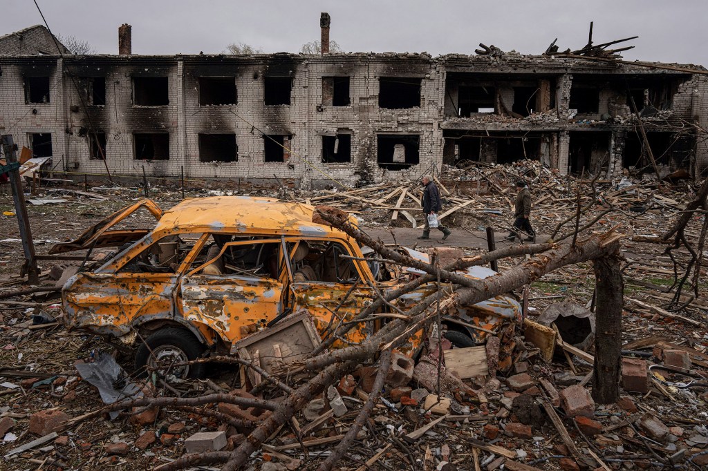 Men walk in a street destroyed by shellings in Chernihiv, Ukraine on April 13. 