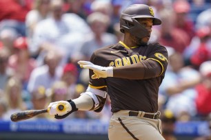 The Padres' Robinson Cano hits an RBI single to score Jurickson Profar during the fourth inning of a game against the Phillies, Thursday, May 19, 2022, in Philadelphia.