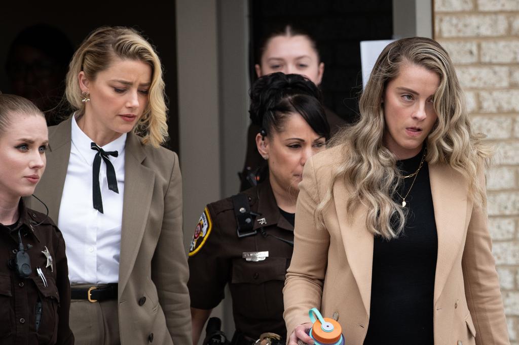 Amber Heard, left, and her sister Whitney Heard, right, depart outside court