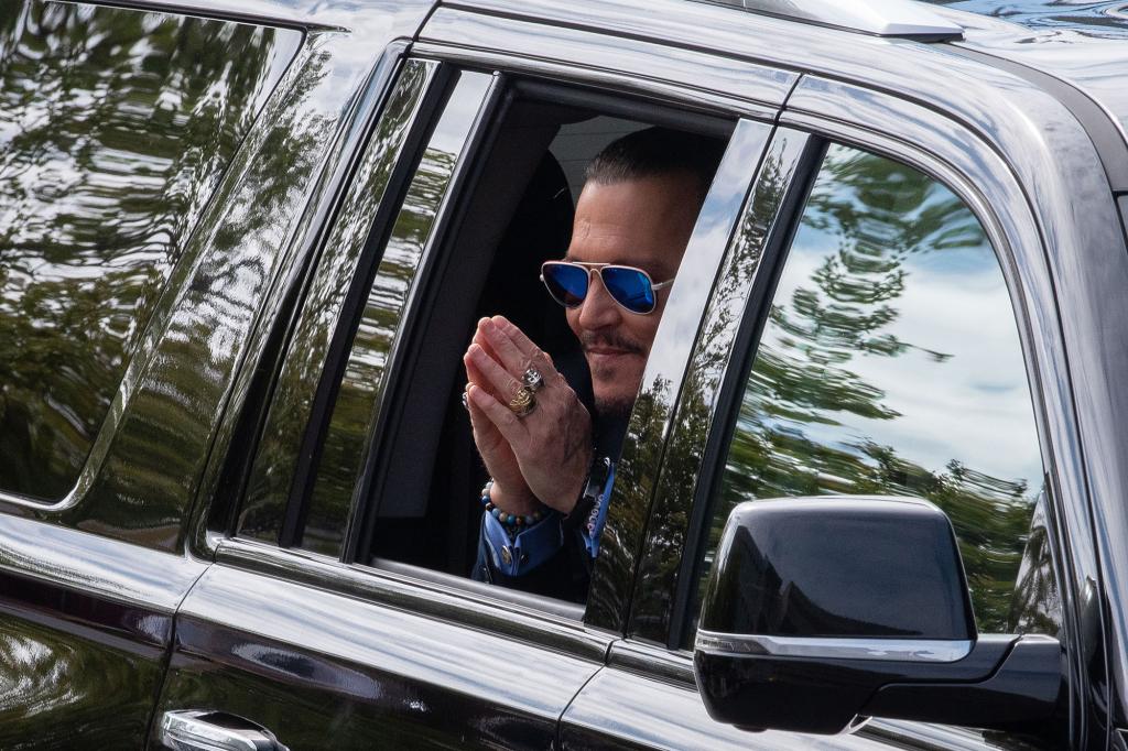 Depp gestures to fans as he arrives outside the court on May 5.