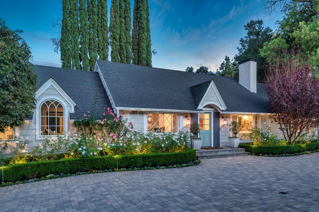 The four-bedroom home stands in Encino, Calif., and surrounded by oak trees.