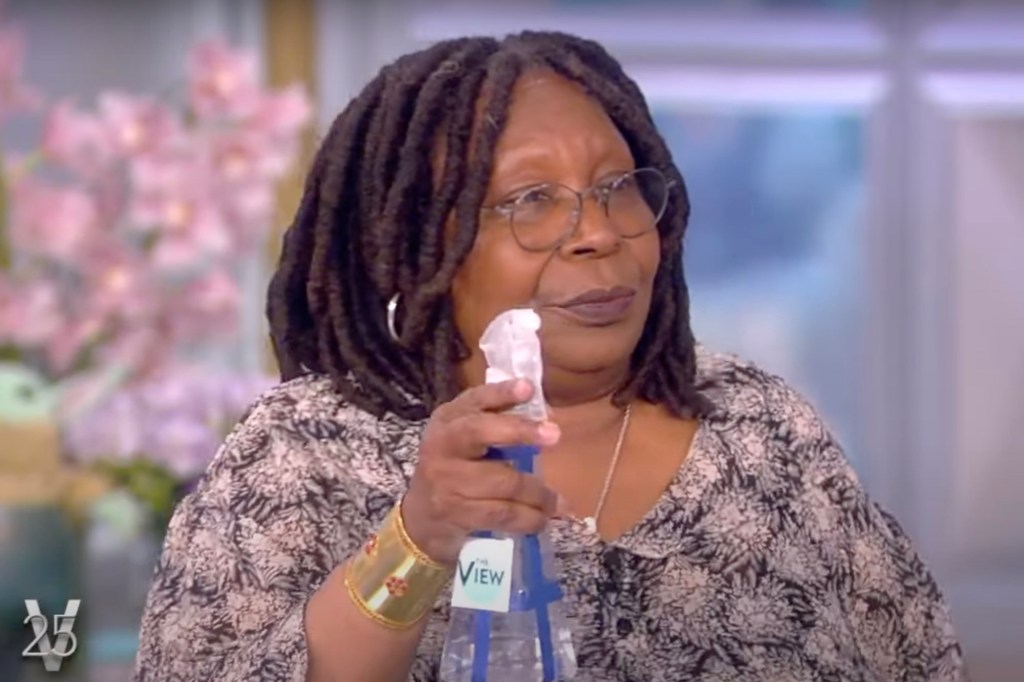 Whoopi Goldberg holding spray water bottle