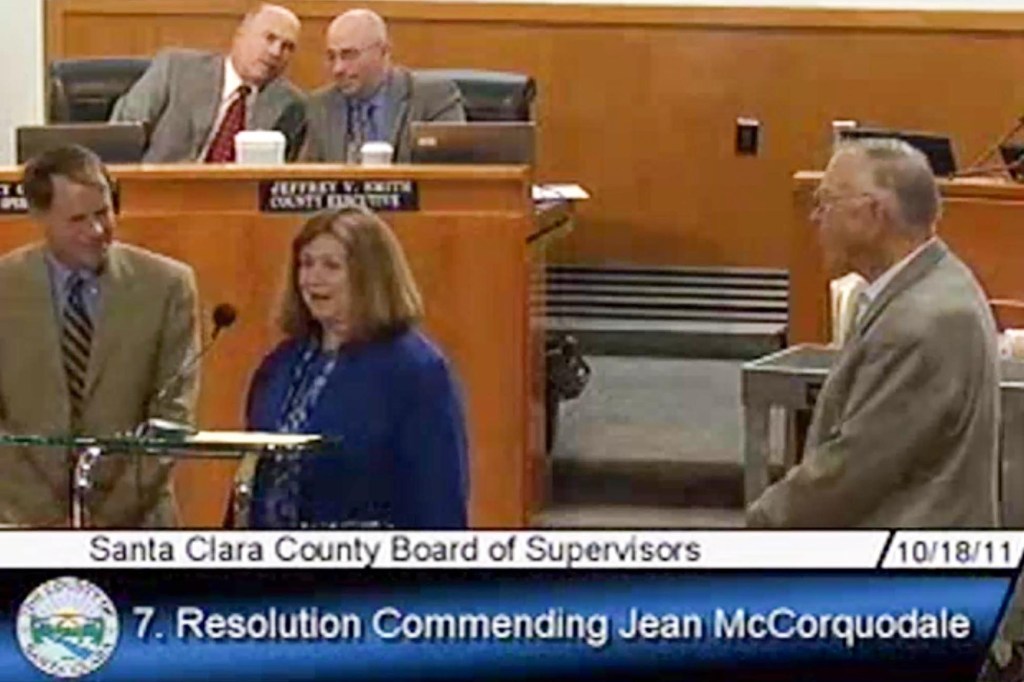 Jean McCorquodale accepts her commendation before the Santa Clara County Board of Supervisors on Oct. 18, 2011, with Supervisor Ken Yeager on her left and her husband and former state senator Dan McCorquodale on her right.