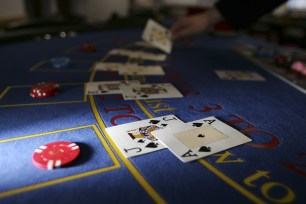 A croupier deals cards on a Black Jack table.