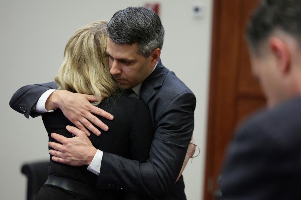 Actor Amber Heard hugs her lawyer Benjamin Rottenborn after the jury ruled in her ex-husband's favor.