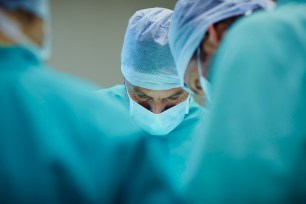 Surgeons working in operating room.