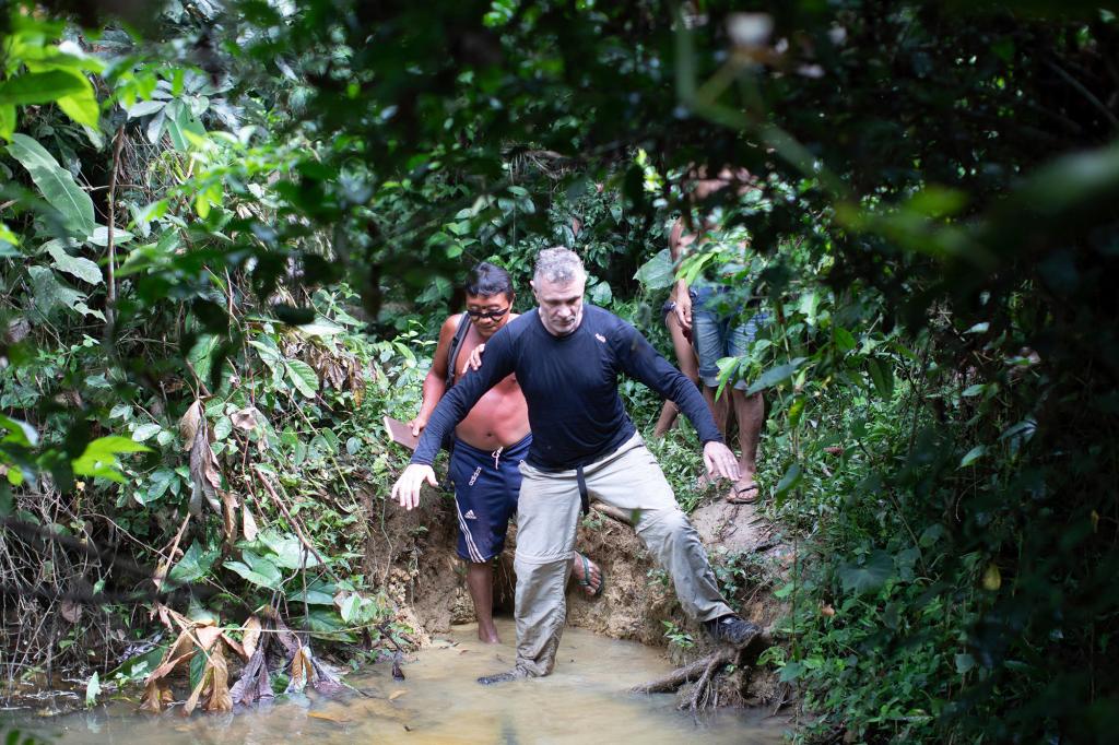British journalist Dom Phillips, right, and a Yanomami Indigenous man walk in Maloca Papiu village, Roraima state, Brazil, Nov. 2019.