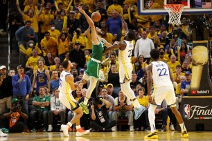 Draymond Green #23 of the Golden State Warriors blocks a shot by Jayson Tatum #0 of the Boston Celtics.
