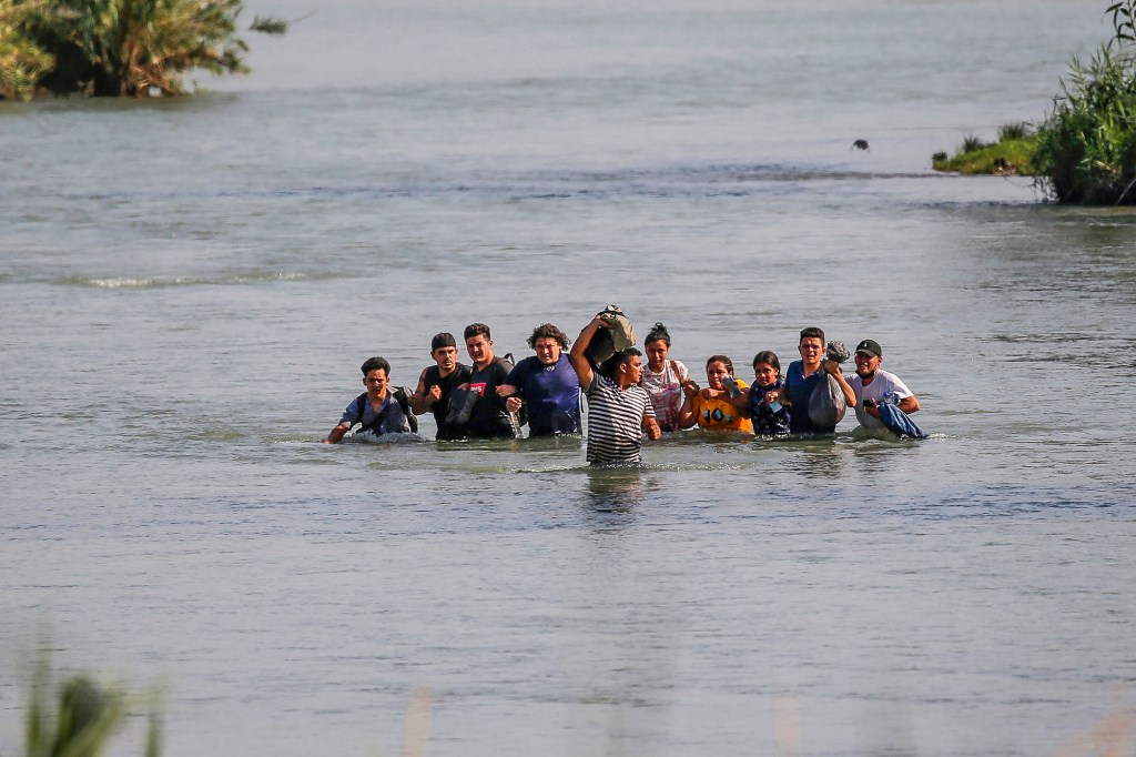 Migrants, mostly from Nicaragua, cross the Rio Grande river into the US, at Eagle Pass, Texas. Flores, who arrived in the US "legally," advocates for a legal immigration system "that works."