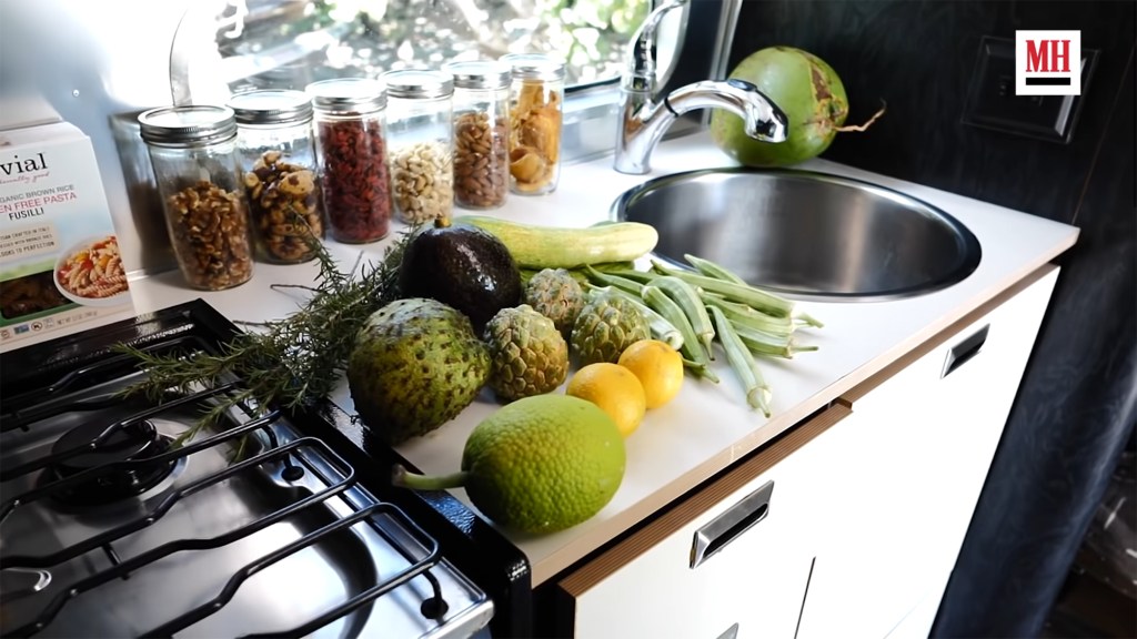 Lenny Kravitz gives Men's health of the foods he eats in his trailer. Here are fruits and vegetables with jars of nuts on the kitchen sink.