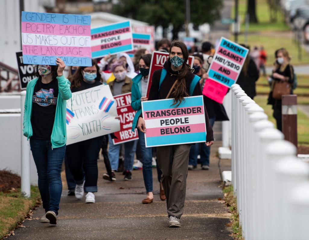 Protestors in support of transgender rights march around the Alabama State House in Montgomery, Ala.
