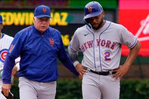 Dominic Smith (right) walks off the field after injuring his ankle.