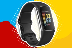 A black Fitbit watch in a red, yellow and blue circle with dots