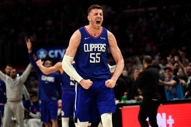 Isaiah Hartenstein #55 of the Los Angeles Clippers celebrates after assisting on three-point basket by Robert Covington #23 against the Utah Jazz during the second half at Crypto.com Arena on March 29, 2022 in Los Angeles, California.