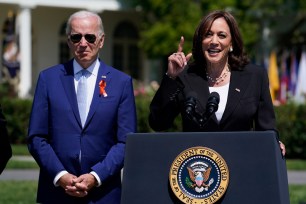 Vice President Kamala Harris speaks as President Joe Biden looks on