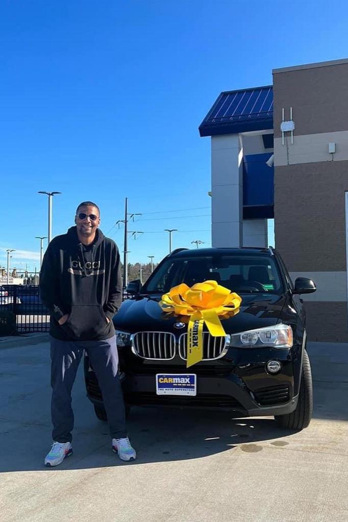 Raymond Lester is seen with a new BMW.