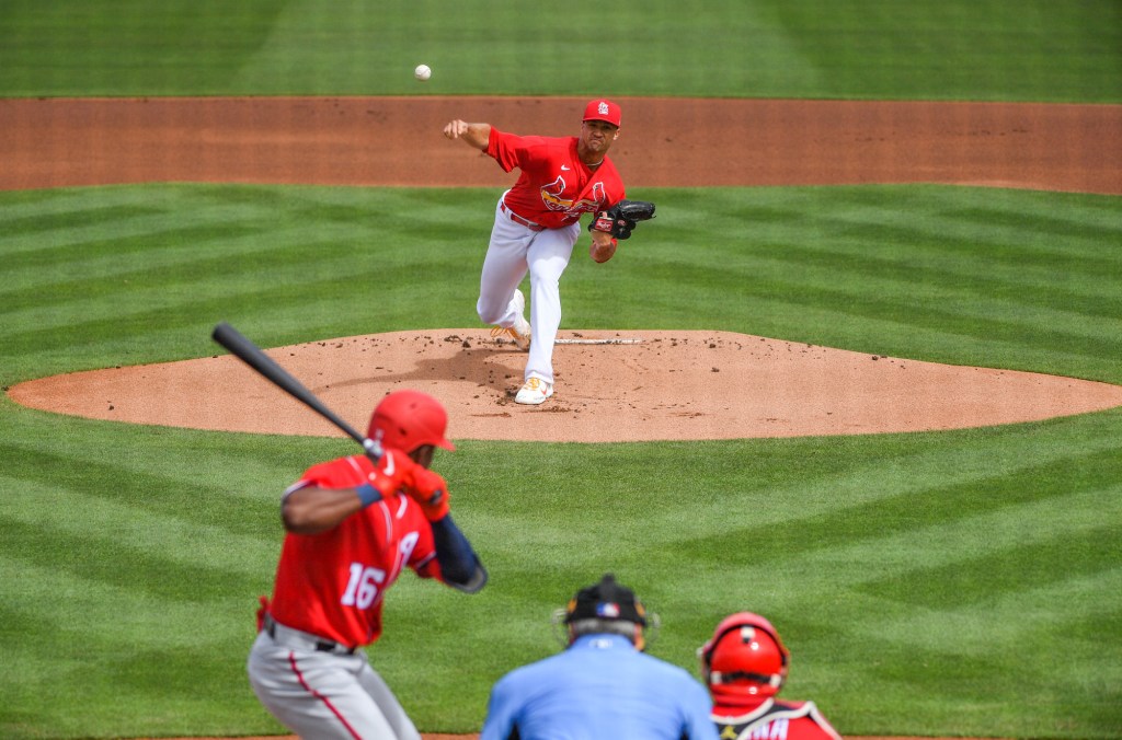 Jack Flaherty #22 of the St. Louis Cardinals delivers the first pitch of spring training against Victor Robles #16 of the Washington Nationals in the first inning at Roger Dean Chevrolet Stadium on February 28, 2021 in Jupiter, Florida. 