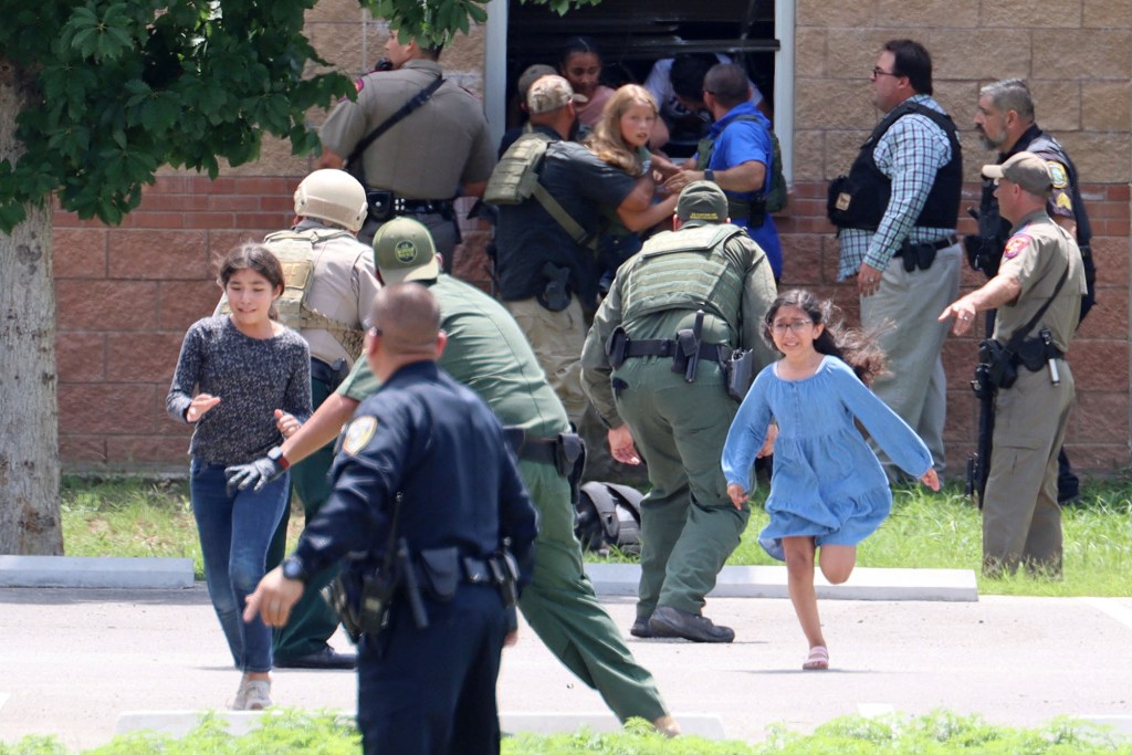 Children run to safety after escaping from a window.