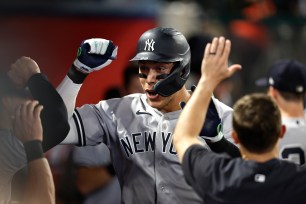 Aaron Judge celebrates after hitting his 50th homer.