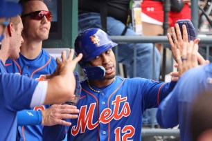 Francisco Lindor celebrates after scoring on Daniel Vogelbach's RBI single in the second inning of the Mets' 10-2 win over the Reds.