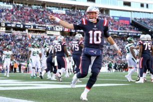 Mac Jones #10 of the New England Patriots celebrates after a touchdown \f in the game at Gillette Stadium on October 24, 2021 in Foxborough, Massachusetts.