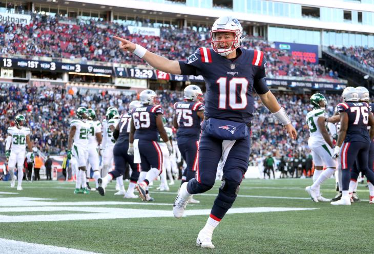 Mac Jones #10 of the New England Patriots celebrates after a touchdown \f in the game at Gillette Stadium on October 24, 2021 in Foxborough, Massachusetts.