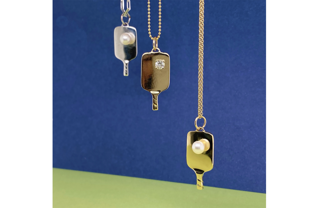 Three pickleball paddle necklaces in gold, silver and rose gold 