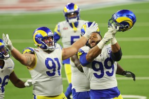 Aaron Donald #99 and Greg Gaines #91of the Los Angeles Rams react during the fourth quarter of Super Bowl LVI against the Cincinnati Bengals at SoFi Stadium on February 13, 2022 in Inglewood, California.