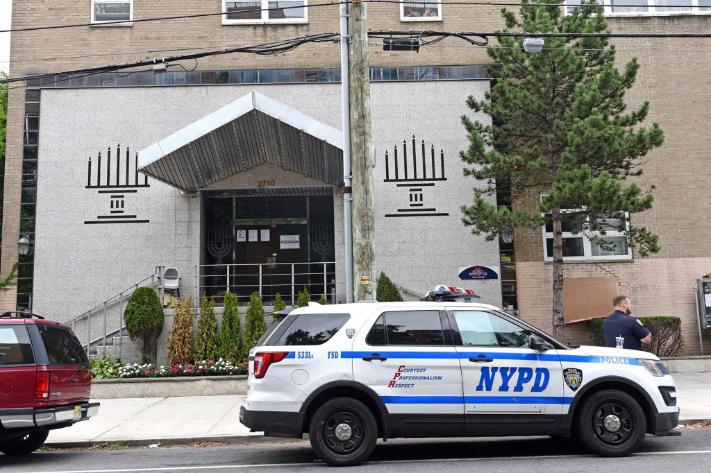 NYPD car parked in front of the scene of the crime. 