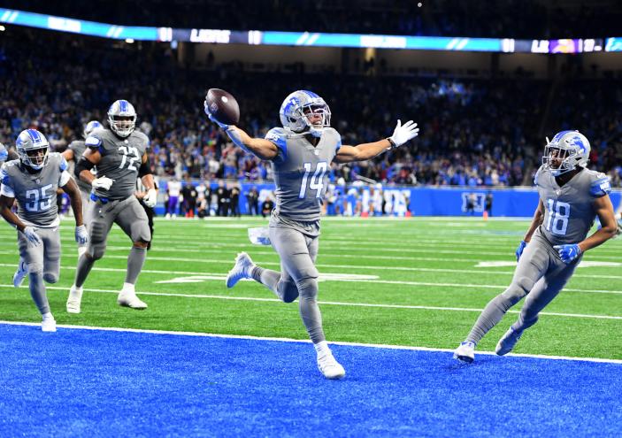 Amon-Ra St. Brown #14 of the Detroit Lions celebrates after catching a touchdown as the time expired to defeat the Minnesota Vikings 29-27 at Ford Field on December 05, 2021 in Detroit, Michigan.