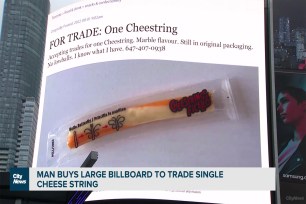 A photo of the cheese-stick advertisement placed on the billboard Angel Domingo bought is shown in Yonge-Dundas Square.