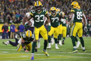 Aaron Jones #33 of the Green Bay Packers reacts after scoring a three-yard rushing touchdown against the Chicago Bears during the third quarter of the NFL game at Lambeau Field