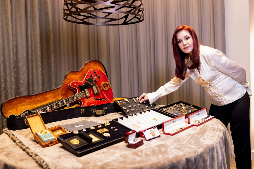Priscilla Presley looks at a collection of personal jewelry of Elvis Presley.