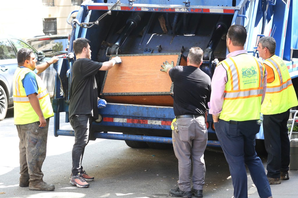 A clean up crew is taking items out of Ivana Trump's 10 East 64th Street, Manhattan, NY home.